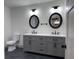 Bathroom with double vanity, modern mirrors, and gray cabinets at 609 W Pearl St, Trafalgar, IN 46181