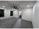 Spacious bedroom with plush carpet, ceiling fan, and view of the bathroom at 609 W Pearl St, Trafalgar, IN 46181