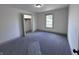 This carpeted bedroom has an open closet, window and neutral paint ready for new decor at 609 W Pearl St, Trafalgar, IN 46181