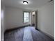 Comfortable bedroom with neutral carpet, closet and a window with neighborhood view at 609 W Pearl St, Trafalgar, IN 46181