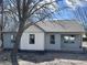 Charming exterior of a one story home with light blue siding and white trim at 609 W Pearl St, Trafalgar, IN 46181