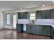 Well-lit kitchen with modern countertops, stainless steel sink, and sleek cabinetry at 609 W Pearl St, Trafalgar, IN 46181