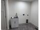 Laundry room with utility sink and tile floors at 609 W Pearl St, Trafalgar, IN 46181