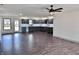 Spacious open floor plan with modern kitchen, hardwood floors and a ceiling fan at 609 W Pearl St, Trafalgar, IN 46181