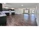 Open floor plan showcasing the spacious living room and modern kitchen with hardwood floors at 609 W Pearl St, Trafalgar, IN 46181