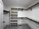 Spacious walk-in closet with shelving, hanging racks, and soft gray carpet at 609 W Pearl St, Trafalgar, IN 46181