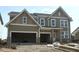 Inviting new construction home with a three-car garage and stylish exterior at 6229 Hampton Walk Blvd, McCordsville, IN 46055