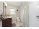 Bathroom with shower stall, vanity with sink, toilet and window at 7026 Spring Mill Rd, Indianapolis, IN 46260
