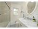 Bright bathroom with marble vanity top, glass enclosed shower, and modern fixtures at 7026 Spring Mill Rd, Indianapolis, IN 46260