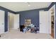 Bedroom featuring ample storage with bookshelves and closets in a relaxing, blue space at 7026 Spring Mill Rd, Indianapolis, IN 46260