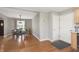 Open concept dining area with hardwood floors, seamless transition to the kitchen and hallway spaces at 7026 Spring Mill Rd, Indianapolis, IN 46260