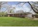 A well-maintained, single-story brick home with a spacious lawn and backyard at 7026 Spring Mill Rd, Indianapolis, IN 46260