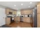 Well-lit kitchen with stainless steel appliances, granite countertops, and warm wood cabinetry at 7026 Spring Mill Rd, Indianapolis, IN 46260