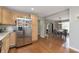 Spacious kitchen flows into a dining area with hardwood floors and stainless steel refrigerator at 7026 Spring Mill Rd, Indianapolis, IN 46260