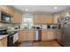 Well-lit kitchen with stainless steel appliances, granite countertops, and wooden cabinets at 7026 Spring Mill Rd, Indianapolis, IN 46260