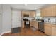 Functional kitchen with stainless appliances, granite counters and updated cabinetry, with hardwood floors at 7026 Spring Mill Rd, Indianapolis, IN 46260