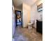 Bathroom features a modern vanity, toilet, and doorway leading to a kitchen with white appliances at 7132 N Stafford Ln, Martinsville, IN 46151