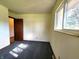 This bedroom has a window for natural light, neutral walls, and gray carpet at 7132 N Stafford Ln, Martinsville, IN 46151