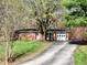 Charming brick ranch home with an attached two-car garage surrounded by lush trees at 7132 N Stafford Ln, Martinsville, IN 46151