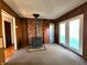 Cozy living area featuring a charming wood-burning stove and access to the backyard through french doors at 7132 N Stafford Ln, Martinsville, IN 46151