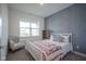 Cozy bedroom featuring a charming chair and a patterned accent wall at 714 Faudree Dr, Westfield, IN 46074