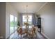 Bright dining room with sliding glass door, modern light fixture, and neutral decor at 714 Faudree Dr, Westfield, IN 46074