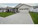 Long concrete driveway leading up to a two-car garage on a home with green lawn at 714 Faudree Dr, Westfield, IN 46074