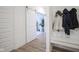 Hallway with hardwood floors featuring a sliding barn door and coat rack at 714 Faudree Dr, Westfield, IN 46074