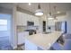 Well-lit kitchen with a kitchen island, white cabinets, and modern stainless appliances at 714 Faudree Dr, Westfield, IN 46074
