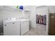 Well-equipped laundry room with modern washer and dryer, shelving, and access to a walk-in closet at 714 Faudree Dr, Westfield, IN 46074