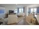 Living room featuring a white sofa and chair, a media center, and large windows at 714 Faudree Dr, Westfield, IN 46074
