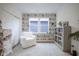 Inviting sitting room featuring an accent wall with bookshelf-patterned wallpaper at 714 Faudree Dr, Westfield, IN 46074