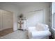 Sitting room features a soft white arm chair, a large blue rug, and floral-painted dresser at 714 Faudree Dr, Westfield, IN 46074