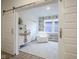 Bright sitting room with white chair, patterned wallpaper, and barn door at 714 Faudree Dr, Westfield, IN 46074