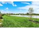 Beautiful backyard with views of a serene pond featuring a fountain, lush green grass, and landscaping at 725 Meadowbrook Ln, Franklin, IN 46131