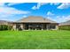 Beautiful backyard with a covered patio, lush green grass, and a well-maintained brick home at 725 Meadowbrook Ln, Franklin, IN 46131