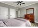 Bedroom boasting hardwood floors, ceiling fan, closet and dresser with mirror at 725 Meadowbrook Ln, Franklin, IN 46131
