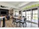 Bright dining area featuring modern finishes, fireplace, and large sliding glass doors to outdoor patio at 725 Meadowbrook Ln, Franklin, IN 46131