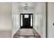 Elegant entryway featuring a modern chandelier, wainscoting, and a stylish rug leading to the front door at 725 Meadowbrook Ln, Franklin, IN 46131