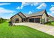 Well-maintained home with manicured lawn, black mulch beds, and a three-car garage at 725 Meadowbrook Ln, Franklin, IN 46131