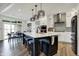 Well-lit kitchen with stainless steel appliances, sleek white cabinets, and a spacious island with seating at 725 Meadowbrook Ln, Franklin, IN 46131