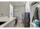 Clean laundry room with modern appliances, white cabinets, and ample counter space at 725 Meadowbrook Ln, Franklin, IN 46131