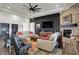 Inviting living room features a stone fireplace, modern furniture, and a contemporary ceiling fan at 725 Meadowbrook Ln, Franklin, IN 46131