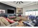 Open-concept living room featuring a stone fireplace, dark accent wall, and comfortable seating at 725 Meadowbrook Ln, Franklin, IN 46131