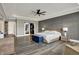 Large main bedroom boasts wainscoting, tray ceiling, and barn doors leading to the bathroom at 725 Meadowbrook Ln, Franklin, IN 46131
