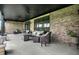 Spacious outdoor patio featuring brick walls, elegant seating, and serene views of the backyard at 725 Meadowbrook Ln, Franklin, IN 46131