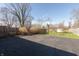 Backyard features a basketball court, lush grass and is enclosed by a wood fence at 7260 Marla Dr, Indianapolis, IN 46256