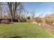 Picture of the large, grassy backyard surrounded by a wood fence at 7260 Marla Dr, Indianapolis, IN 46256
