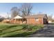Charming brick home with a covered front porch and well-maintained lawn at 7260 Marla Dr, Indianapolis, IN 46256