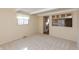 A cozy living room with neutral walls, carpet, and a view into the kitchen at 7260 Marla Dr, Indianapolis, IN 46256